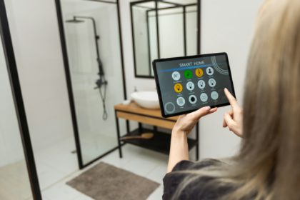 Female hands holding digital tablet with smart home app