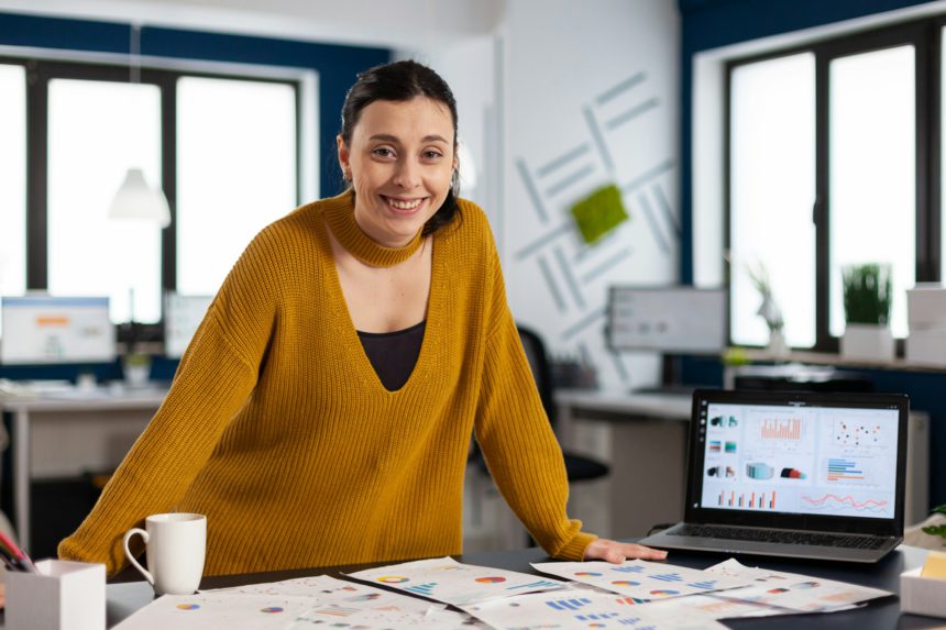 Happy manager standing in office of start up company