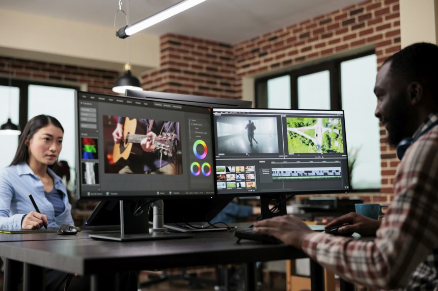 Post production department team leader editing movie footage using advanced technology software.