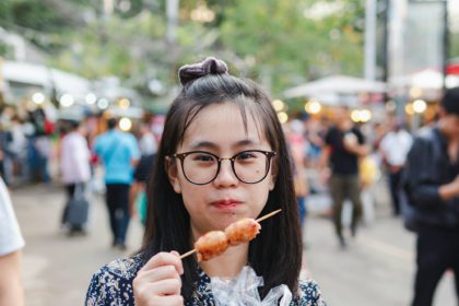 Woman Eating Street Food